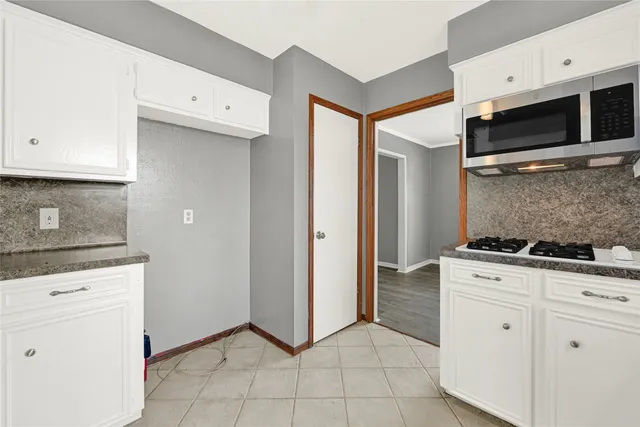a kitchen with stainless steel appliances granite countertop a stove and a microwave