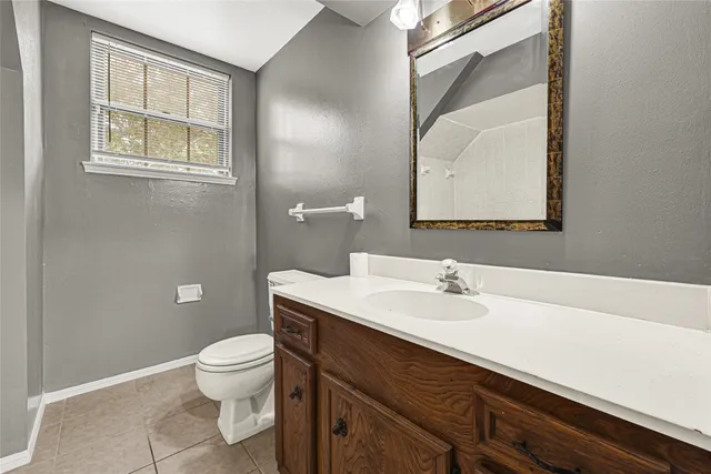 a bathroom with a sink a toilet and mirror