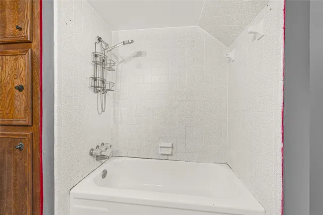 a white bath tub sitting next to a white sink