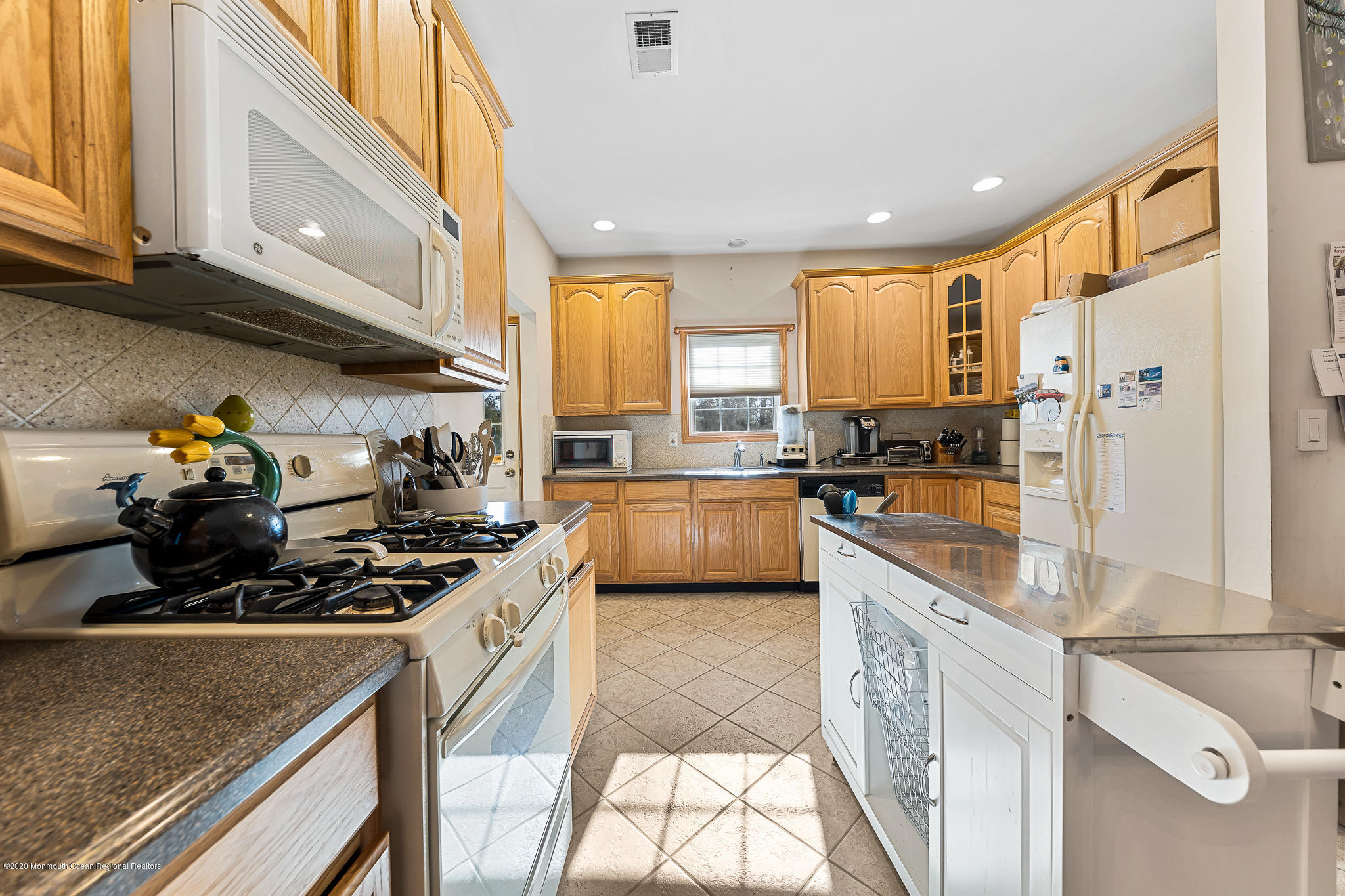 291 Frank Applegate Road Jackson, NJ 08527 - Photo 12 of 38 a kitchen with stainless steel appliances granite countertop a stove a sink and a refrigerator