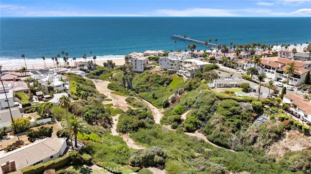an aerial view of a houses with a yard