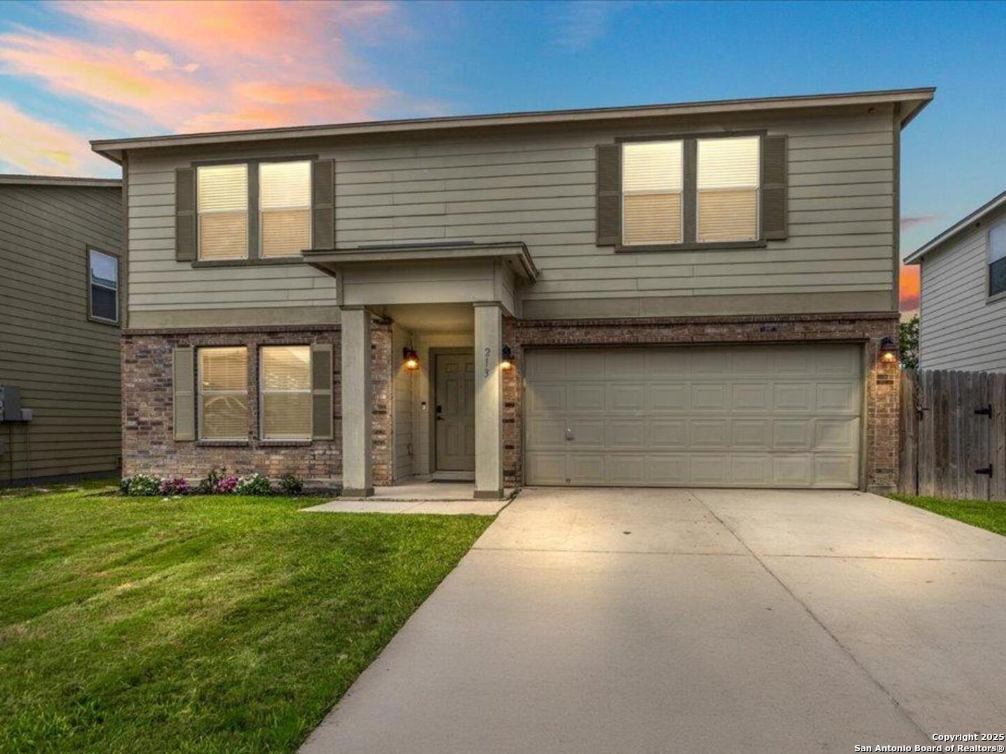 a front view of a house with a yard and garage