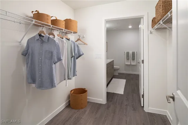 a view of walk in closet with clothes and shoes