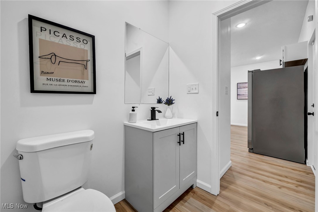 3734 Pennington Road Cleveland, OH 44120 - Photo 28 of 45 Half bathroom with vanity, light wood-type flooring, and recessed lighting