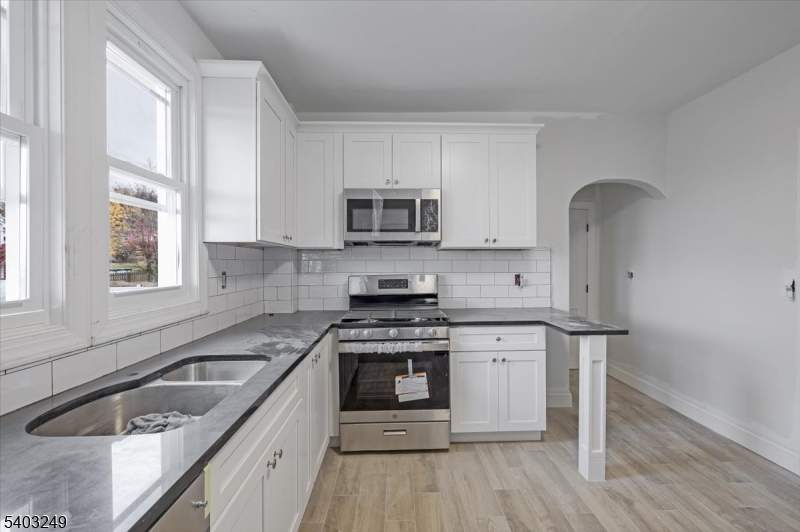 120 High Street Newton, NJ 07860 - Photo 2 of 7 a kitchen with a sink stove top oven and cabinets