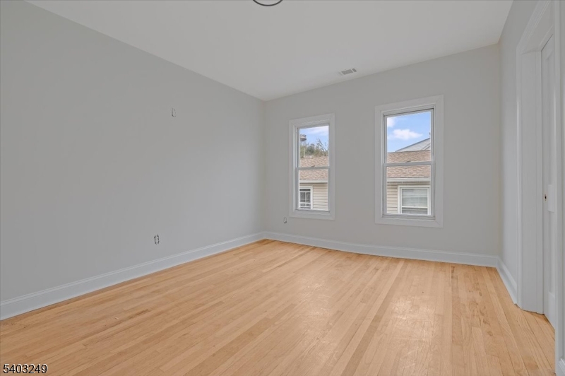 120 High Street Newton, NJ 07860 - Photo 4 of 7 wooden floor in an empty room with a window