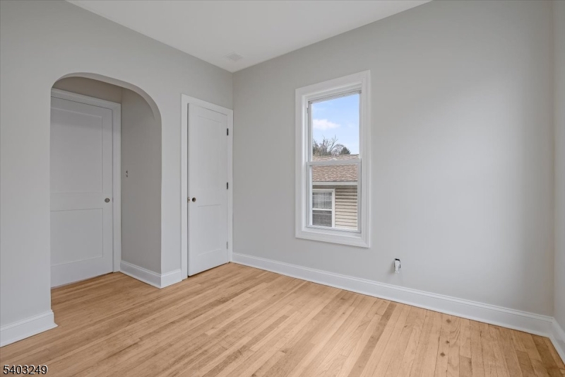 120 High Street Newton, NJ 07860 - Photo 5 of 7 an empty room with wooden floor and windows