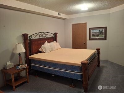37896 Snake River Road Asotin, WA 99402 - Photo 11 of 23 a bedroom with a bed and a lamp on table