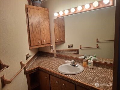 37896 Snake River Road Asotin, WA 99402 - Photo 13 of 23 a bathroom with a granite countertop sink and a mirror