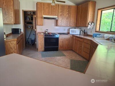 37896 Snake River Road Asotin, WA 99402 - Photo 5 of 23 a kitchen with a sink a stove and cabinets
