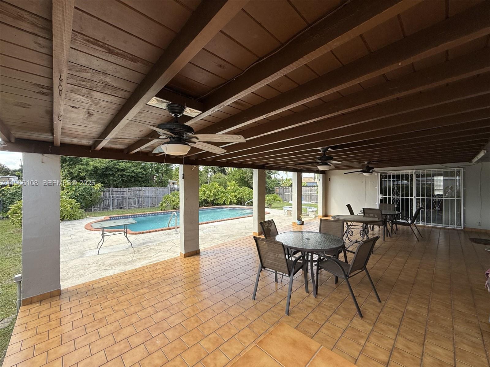 4012 Southwest 102nd Court Miami, FL 33165 - Photo 2 of 10 a view of a dining room with furniture wooden floor and floor to ceiling window