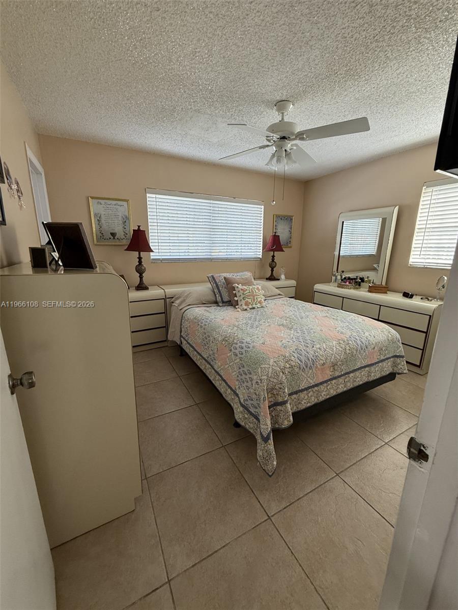 4012 Southwest 102nd Court Miami, FL 33165 - Photo 7 of 10 a bedroom with a bed and ceiling fan