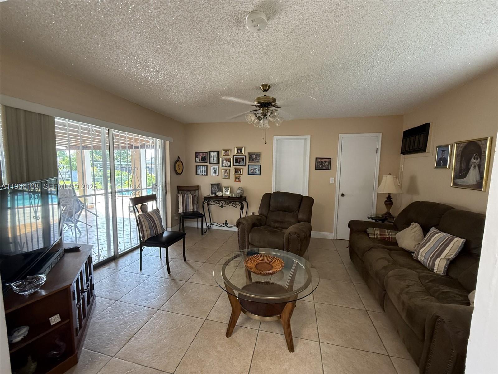 4012 Southwest 102nd Court Miami, FL 33165 - Photo 10 of 10 a living room with furniture a flat screen tv and a window