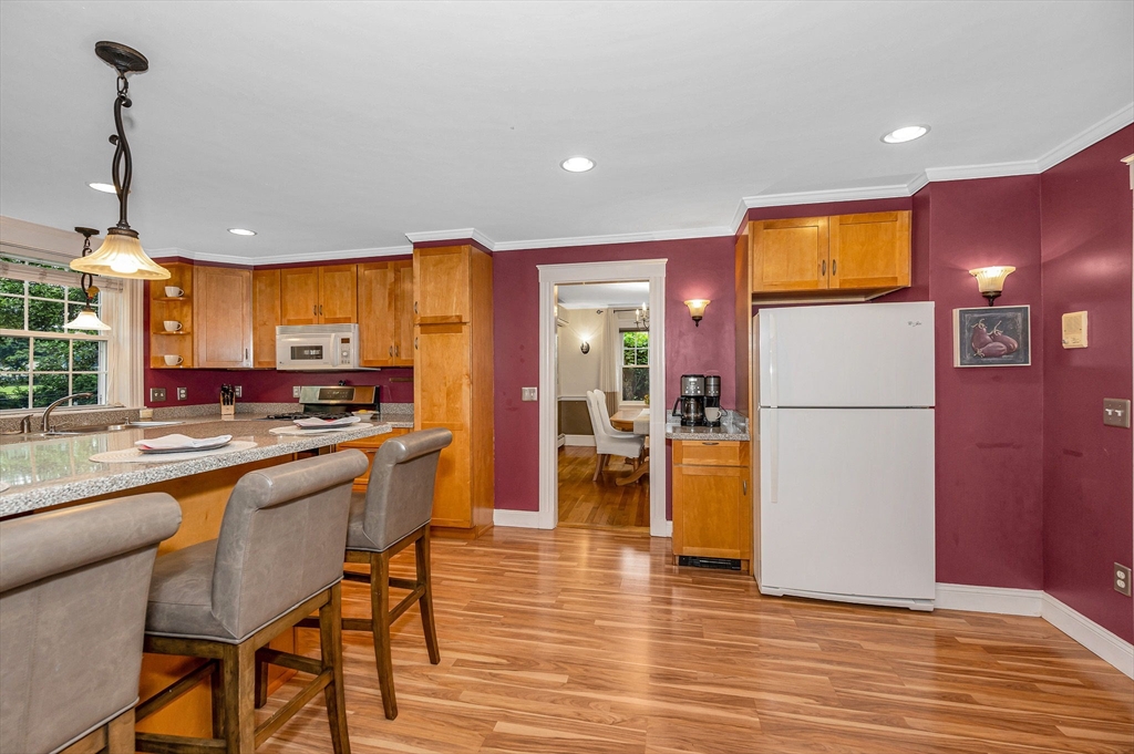 35 Warren Avenue Reading, MA 01867 - Photo 16 of 41 a kitchen with stainless steel appliances granite countertop a refrigerator and a stove top oven