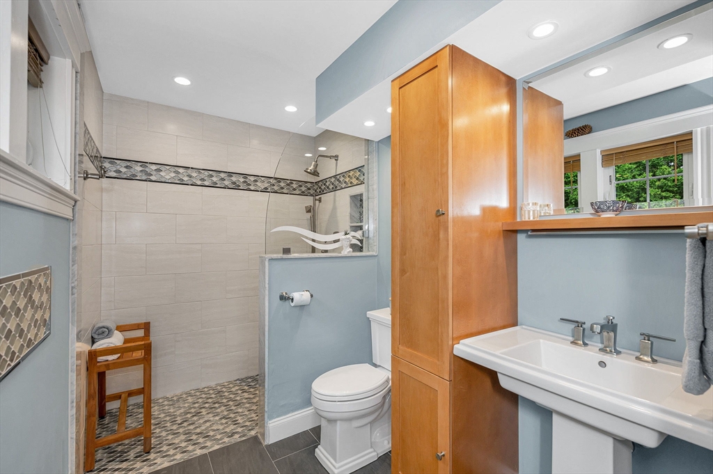 35 Warren Avenue Reading, MA 01867 - Photo 17 of 41 a bathroom with a sink a toilet and shower