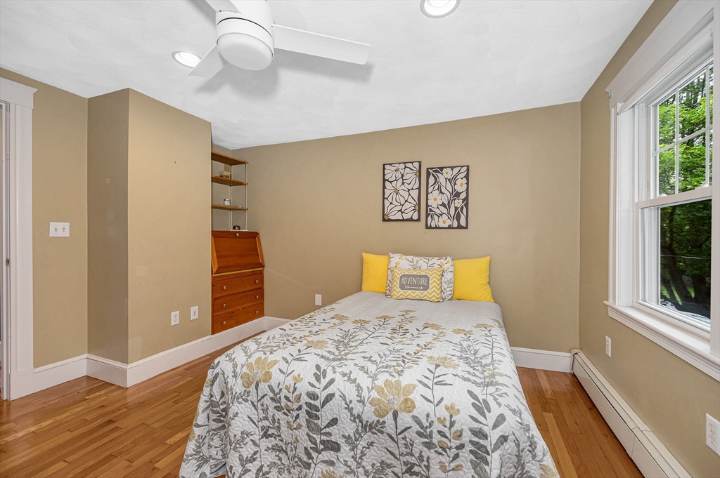 35 Warren Avenue Reading, MA 01867 - Photo 21 of 41 a bedroom with a large bed and a chandelier
