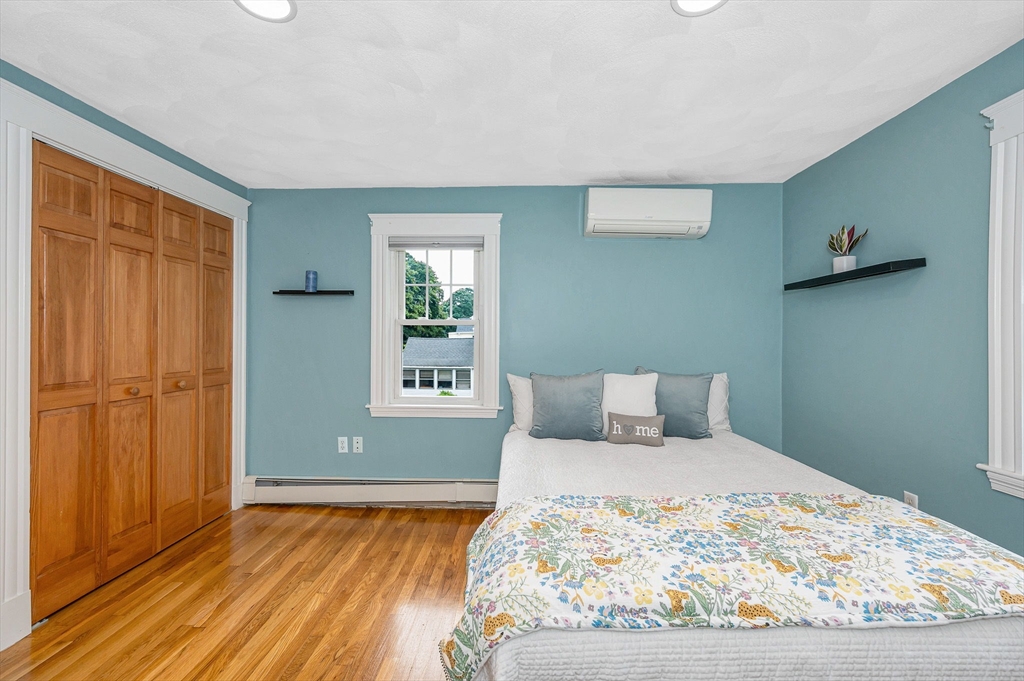 35 Warren Avenue Reading, MA 01867 - Photo 22 of 41 a bedroom with a bed and wooden floor
