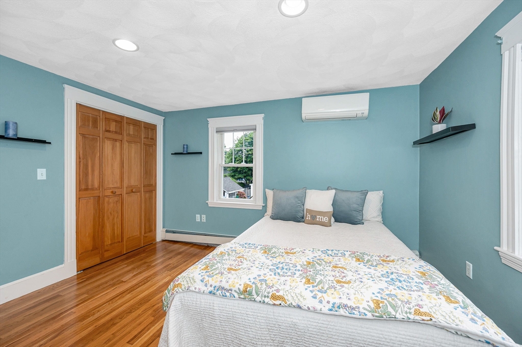 35 Warren Avenue Reading, MA 01867 - Photo 23 of 41 a bedroom with a bed and wooden floor