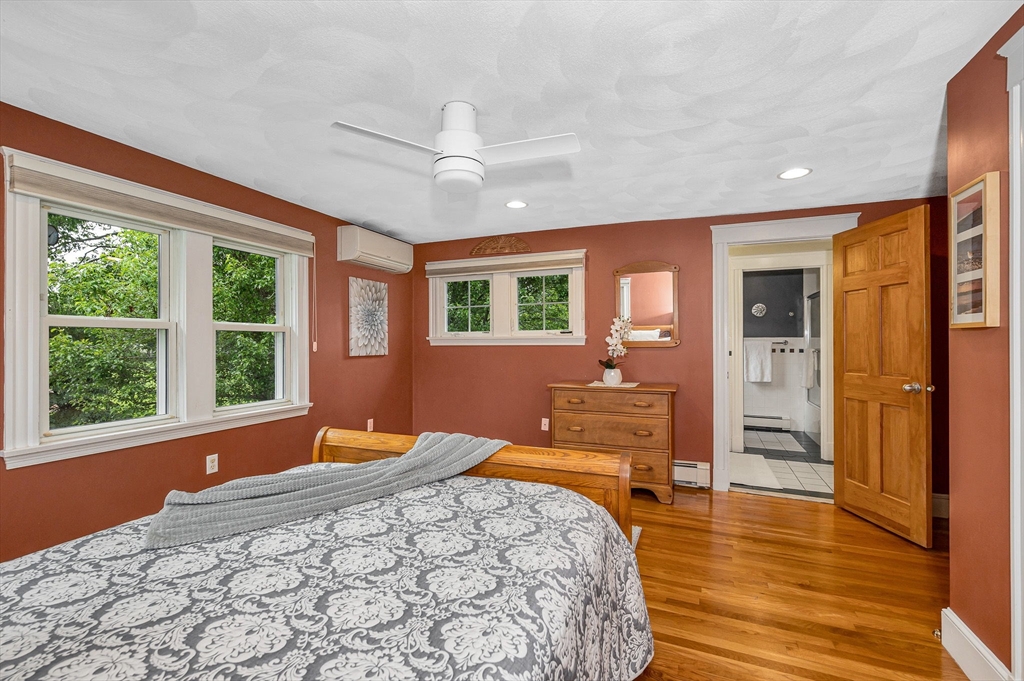 35 Warren Avenue Reading, MA 01867 - Photo 28 of 41 a bedroom with a large bed and wooden floor