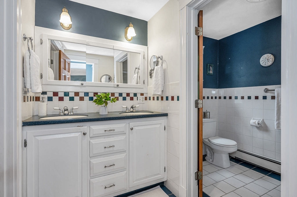 35 Warren Avenue Reading, MA 01867 - Photo 29 of 41 a bathroom with a sink a toilet and a mirror