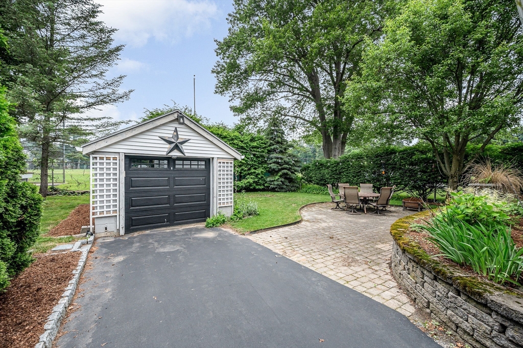 35 Warren Avenue Reading, MA 01867 - Photo 34 of 41 a front view of a house with a yard and garage