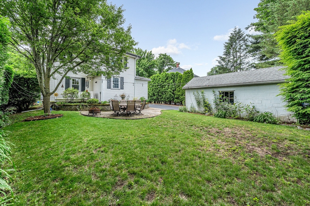 35 Warren Avenue Reading, MA 01867 - Photo 41 of 41 a front view of a house with a garden and trees