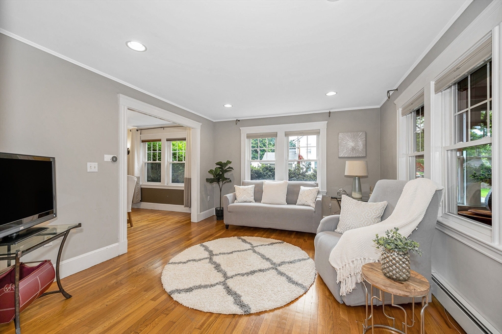 35 Warren Avenue Reading, MA 01867 - Photo 6 of 41 a living room with furniture and a flat screen tv