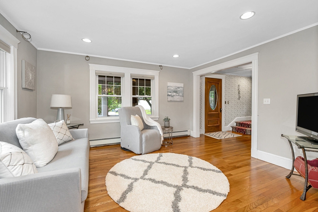 35 Warren Avenue Reading, MA 01867 - Photo 7 of 41 a living room with furniture and a flat screen tv