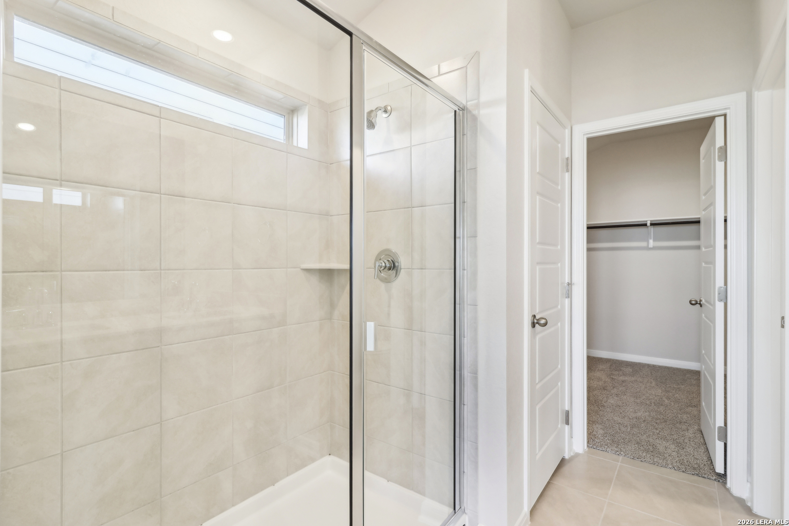 2930 Clemente Way Converse, TX 78109 - Photo 19 of 21 a bathroom with a shower and a glass door