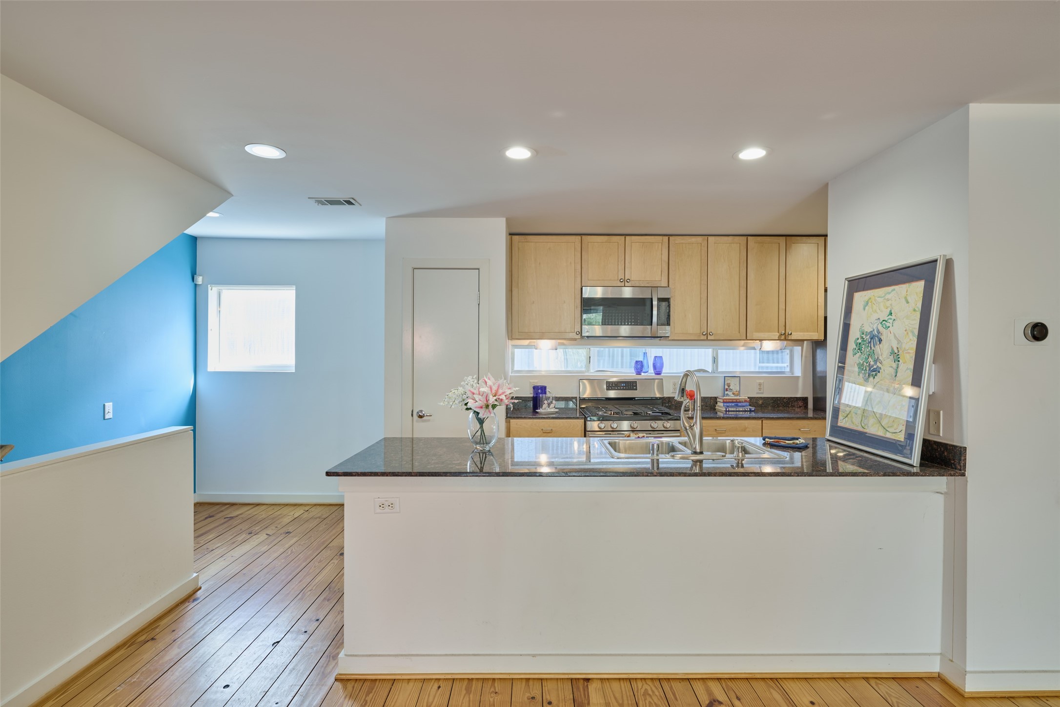 2811 Crawford Street Houston, TX 77004 - Photo 12 of 37 a kitchen with kitchen island granite countertop wooden cabinets and counter top space
