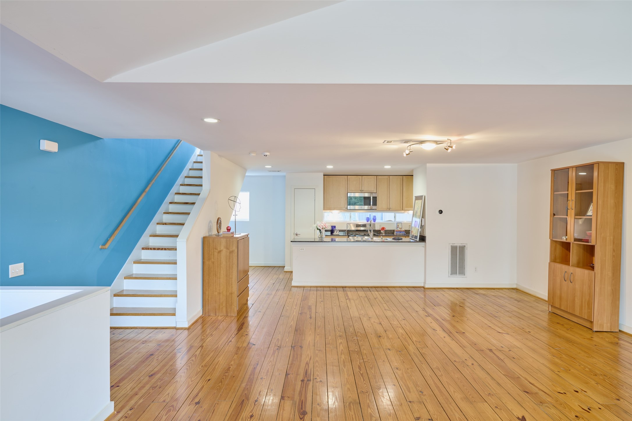 2811 Crawford Street Houston, TX 77004 - Photo 15 of 37 a view of a living room with wooden floor and stairs