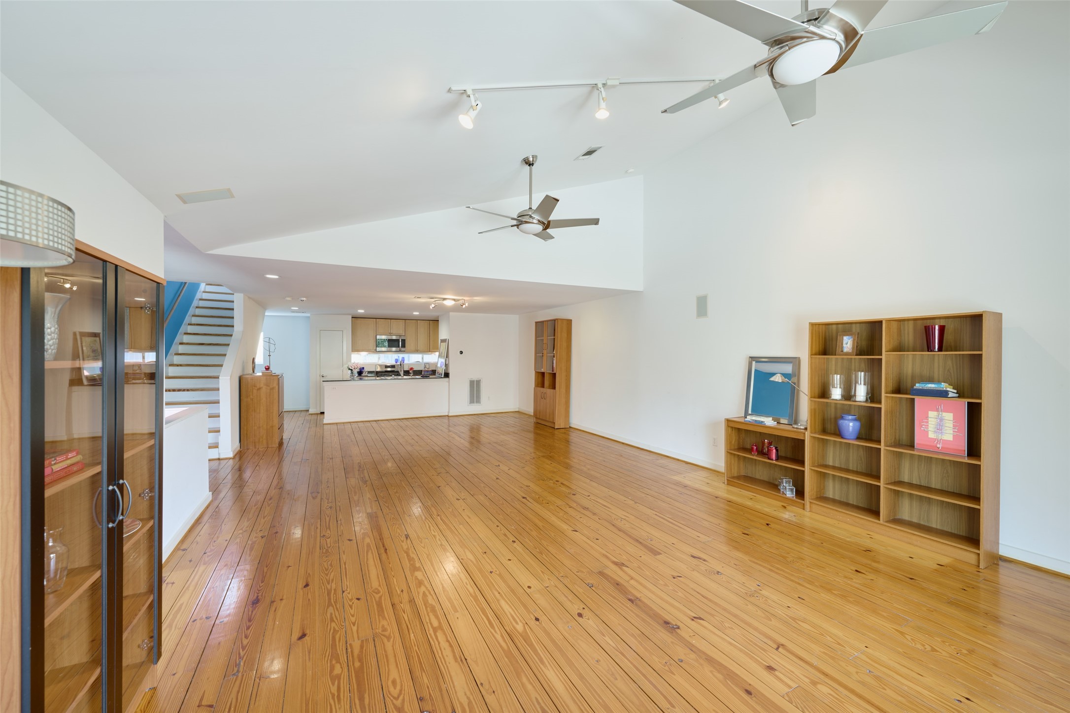 2811 Crawford Street Houston, TX 77004 - Photo 16 of 37 a view of a livingroom with furniture wooden floor and a ceiling fan
