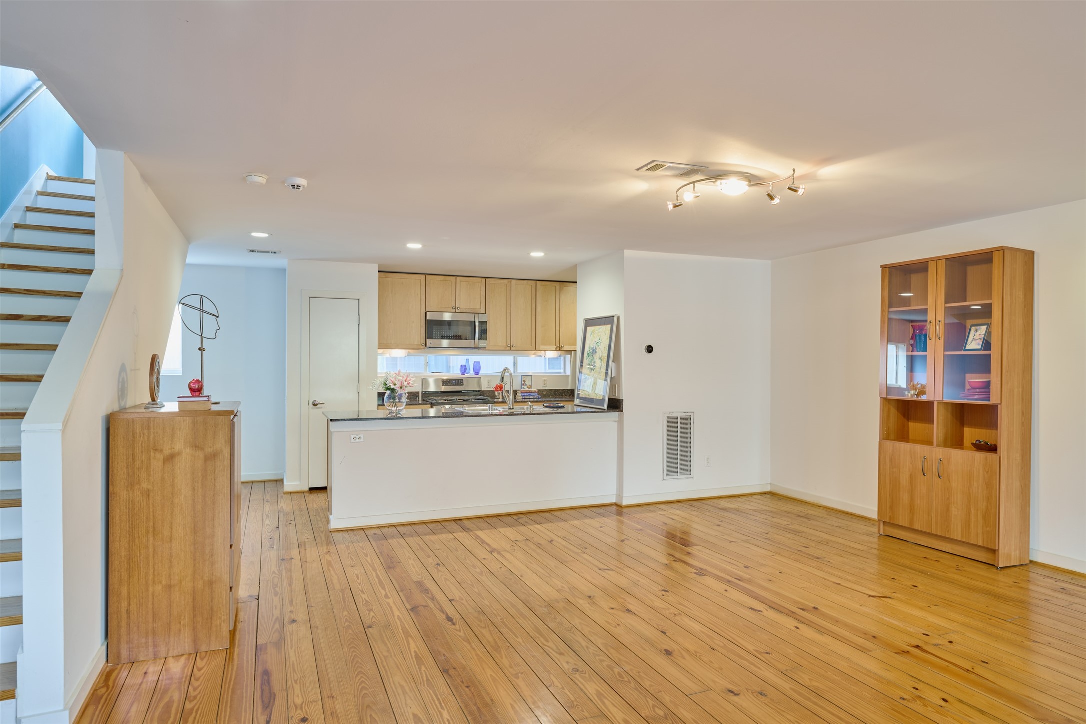 2811 Crawford Street Houston, TX 77004 - Photo 18 of 37 a room with stainless steel appliances kitchen island wooden floors and living room view