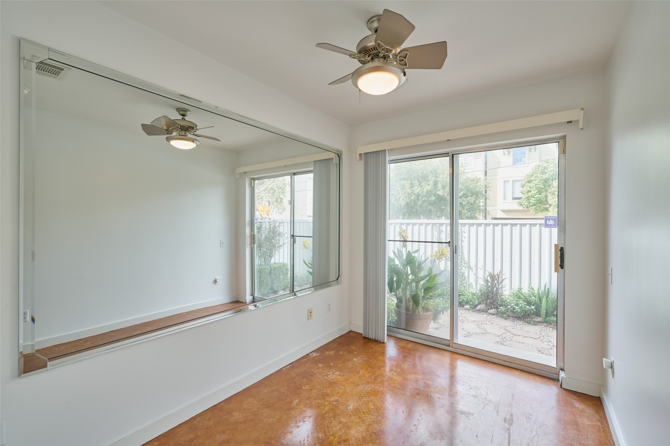 2811 Crawford Street Houston, TX 77004 - Photo 34 of 37 an empty room with wooden floor fan and windows