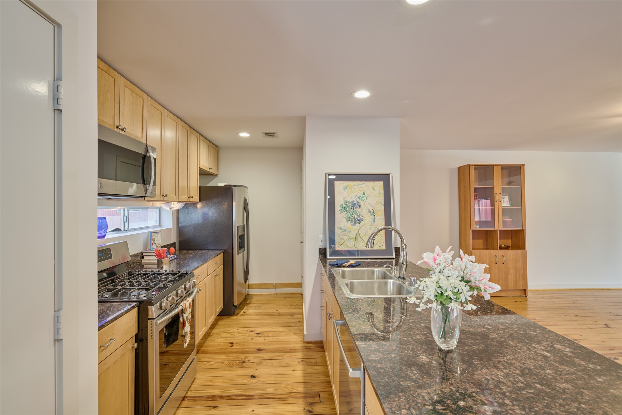 2811 Crawford Street Houston, TX 77004 - Photo 9 of 37 a kitchen with stainless steel appliances kitchen island granite countertop a table and chairs in it