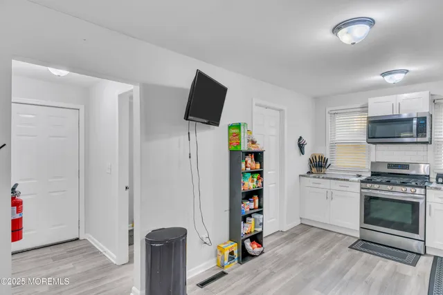 a kitchen with stainless steel appliances a stove and a refrigerator