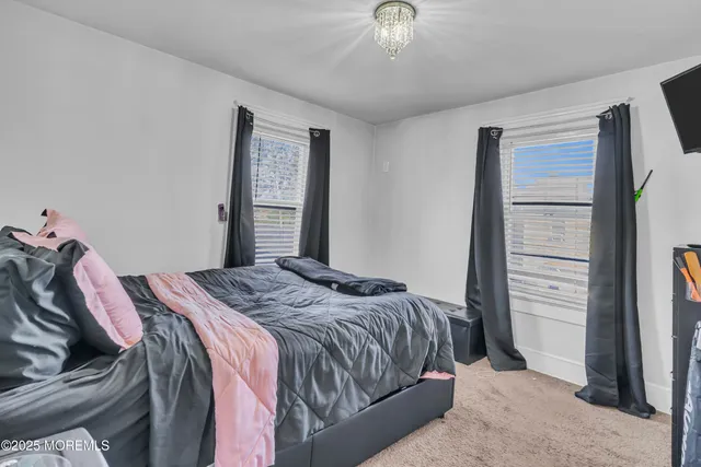 a bathroom with a white bath tub a toilet and a shower