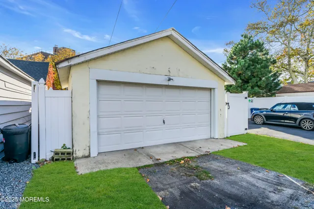 a front view of a house with a garden and yard