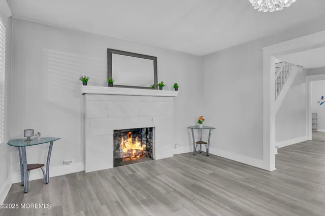 a view of a livingroom with a fireplace a chair and a fireplace