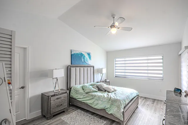 a bedroom with a bed and a lamp on table