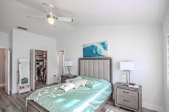a utility room with stainless steel appliances lots of clutter and furniture