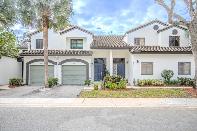 a front view of a house with a garden and plants