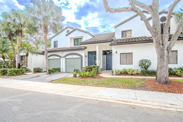 a front view of a house with a yard and a garage