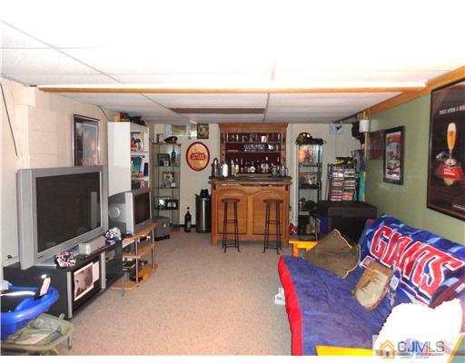 21 Longfield Road New Brunswick, NJ 08901 - Photo 14 of 19 a living room with furniture and a flat screen tv