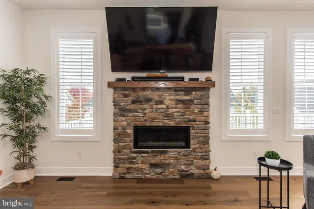 a bedroom with a bed and a flat tv screen on the dresser
