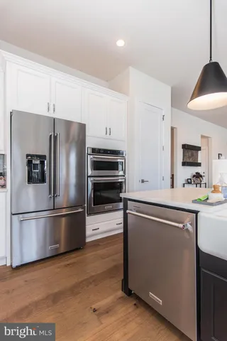 a view of a work space with furniture and wooden floor