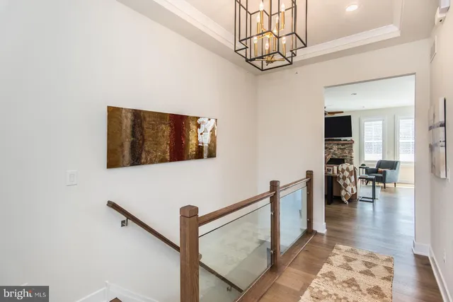 a view of a dining room with furniture wooden floor and a chandelier