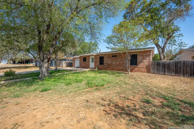 a view of a house with yard and tree s