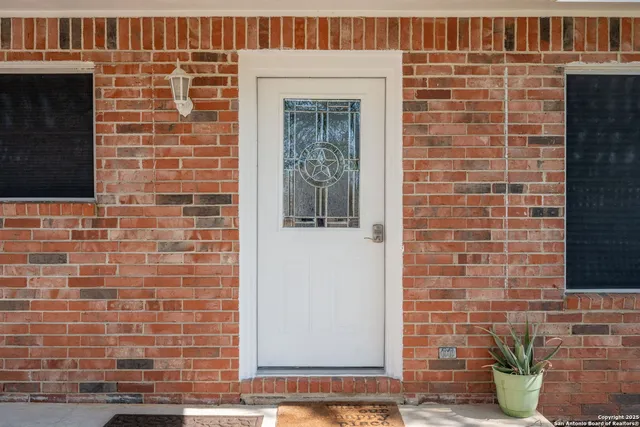 a brick building with a potted plant on it