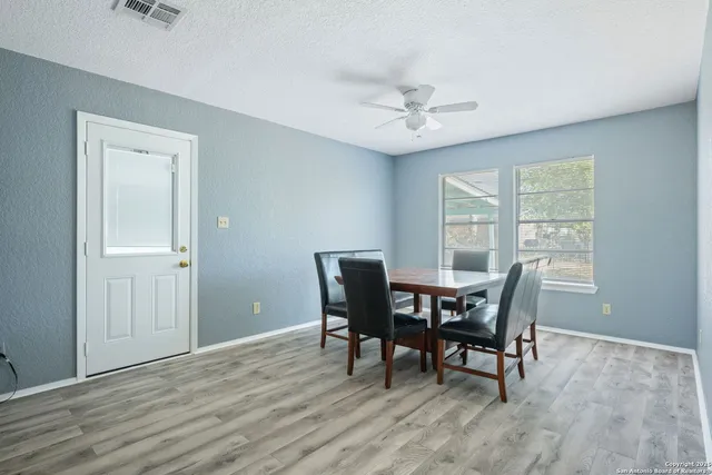 a view of a dining room with furniture window and wooden floor